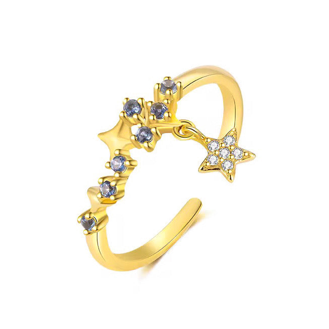Inel reglabil din argint placat cu aur 18K, decorat cu mai multe stele mici cu pietre albastre și o steluță mobilă cu zirconii albe, design fluid și delicat.